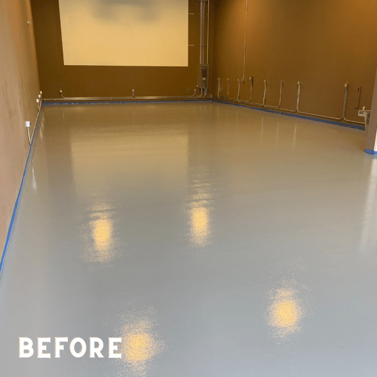 Image of a basement floor with a rough and uneven surface. The concrete floor has stains, cracks, and other damages.